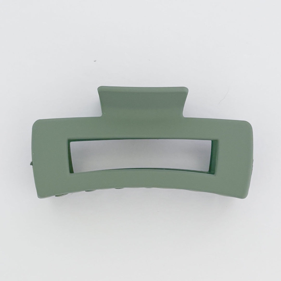 Green hair clip on a white background