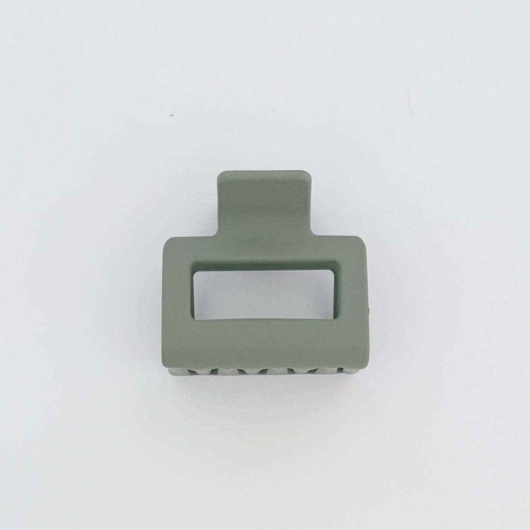 Green rectangular object with cutout on a white background