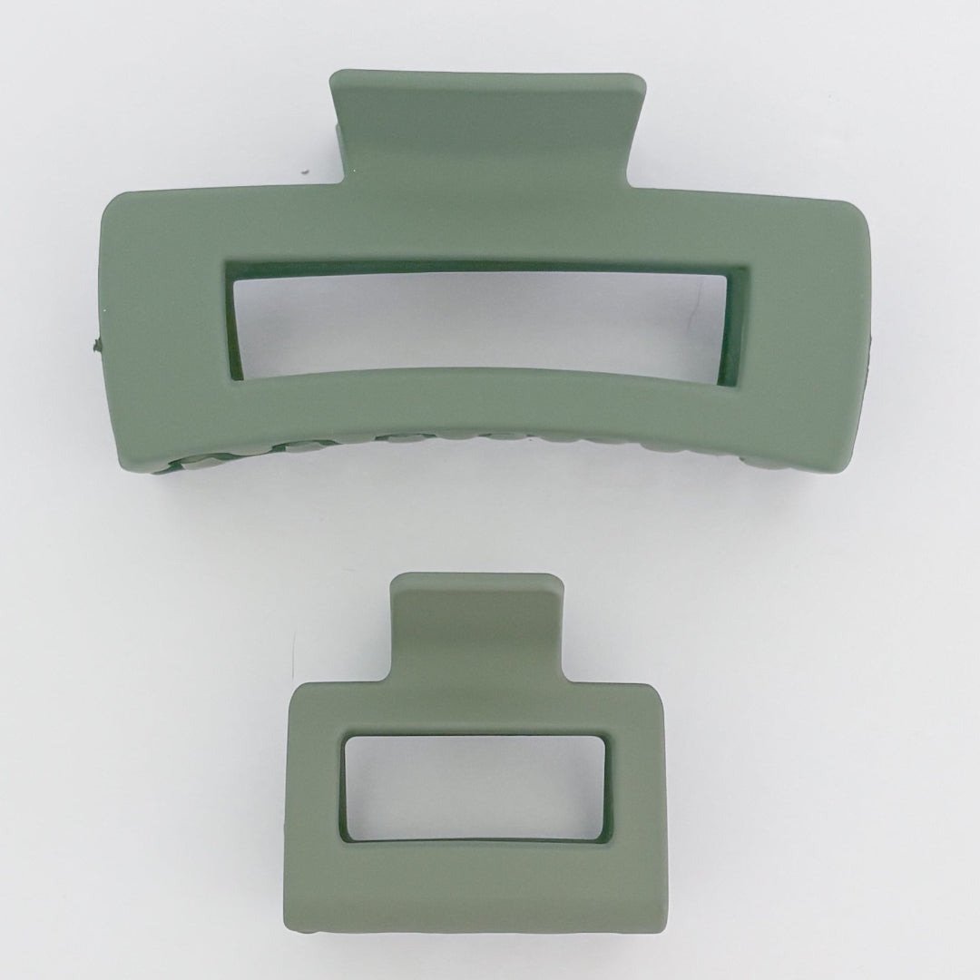 Two green hair clips on a white background