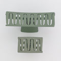Two green metal grates on a white background