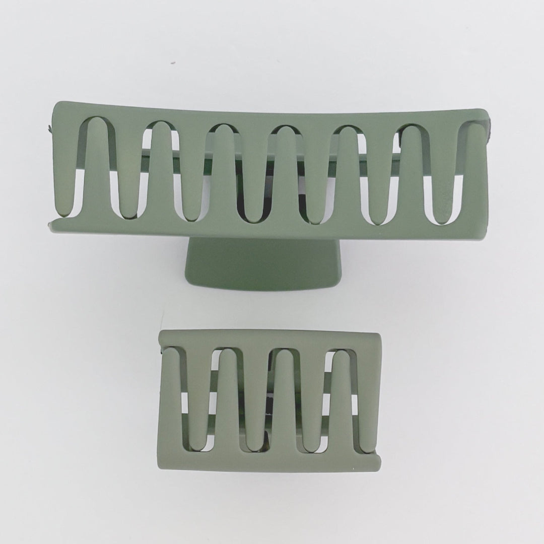 Two green metal grates on a white background