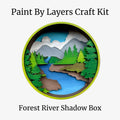 Forest River Shadow Box craft kit with mountains, trees, and river on a white background