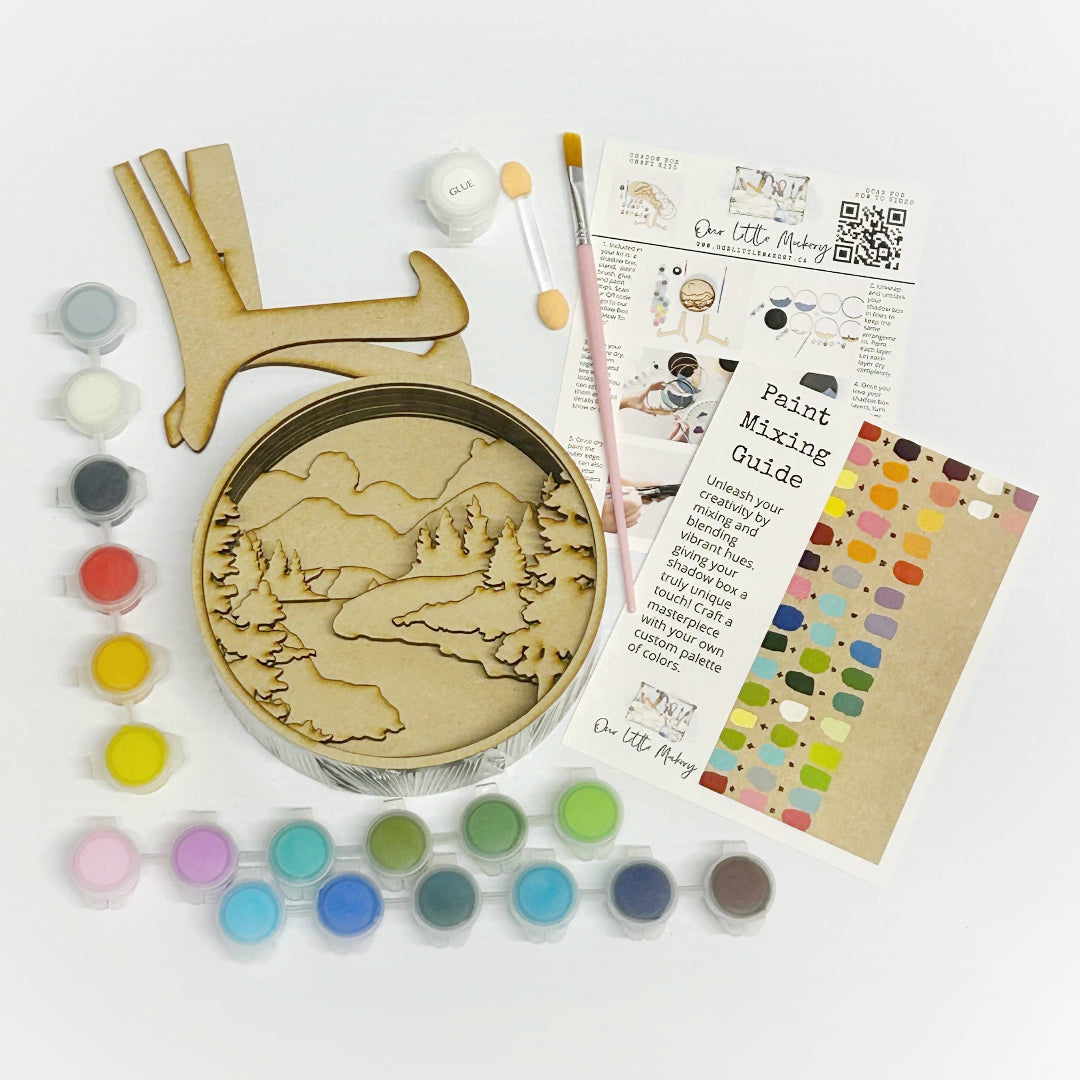 Artistic craft kit with paint, brushes, and a wooden plaque on a white background