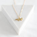 Gold necklace with a fox pendant on a white background