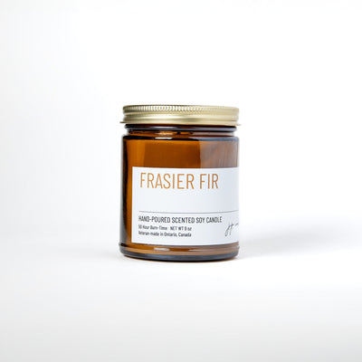 Frasier Fir candle in amber jar with white label on white background
