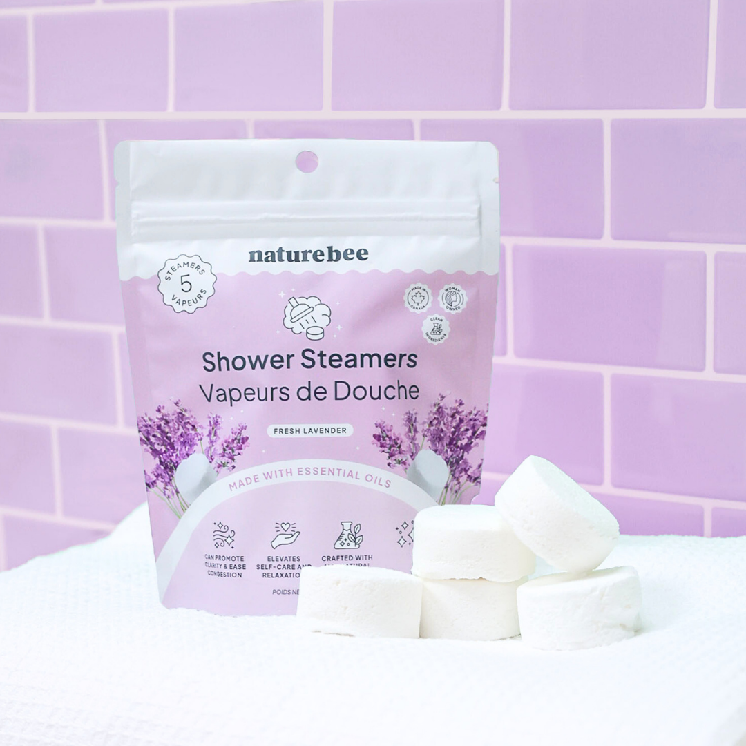 Naturebee shower steamers with packaging on a purple tiled background