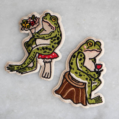 Two frog-themed patches on a gray background