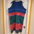 Colorful dress with abstract patterns hanging on a door