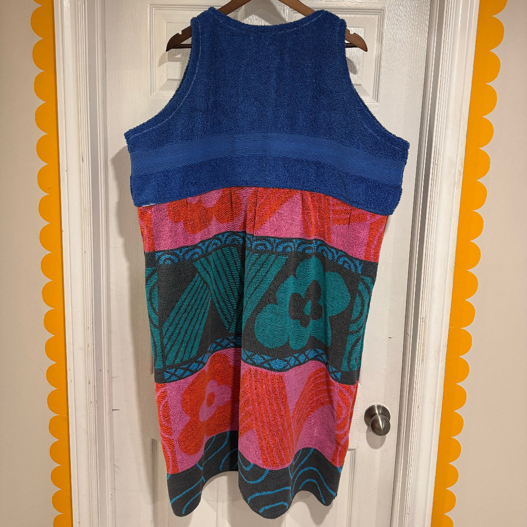 Colorful dress with abstract patterns hanging on a door
