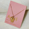 A gold necklace with a quartz stone pendant. The pendant also has the word 