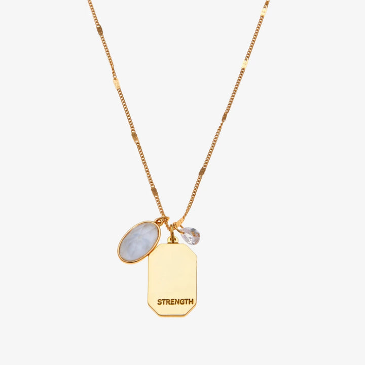 A gold necklace with a quartz stone pendant. The pendant also has the word 