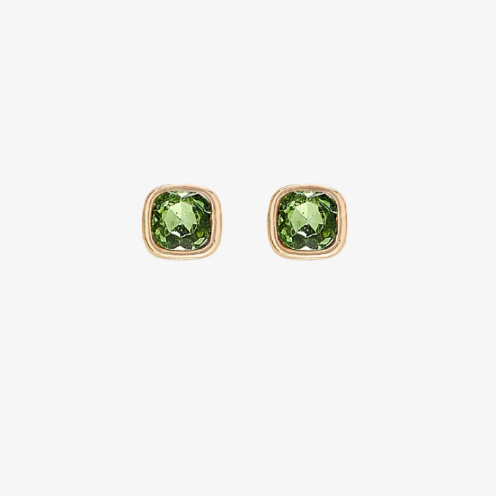 A set of three pairs of peridot earrings displayed on a green card. The set includes a pair of stud earrings, a pair of bar earrings with small peridot beads, and a pair of hoop earrings with dangling peridot stones. The card has the month 
