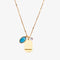 A gold necklace with a turquoise stone pendant. The pendant also has the word 