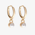 A set of three pairs of pearl earrings displayed on a blue card. The set includes a pair of stud earrings, a pair of bar earrings with small pearl beads, and a pair of hoop earrings with dangling pearl stones. The card has the month "June" and the brand name "Foxy Originals."