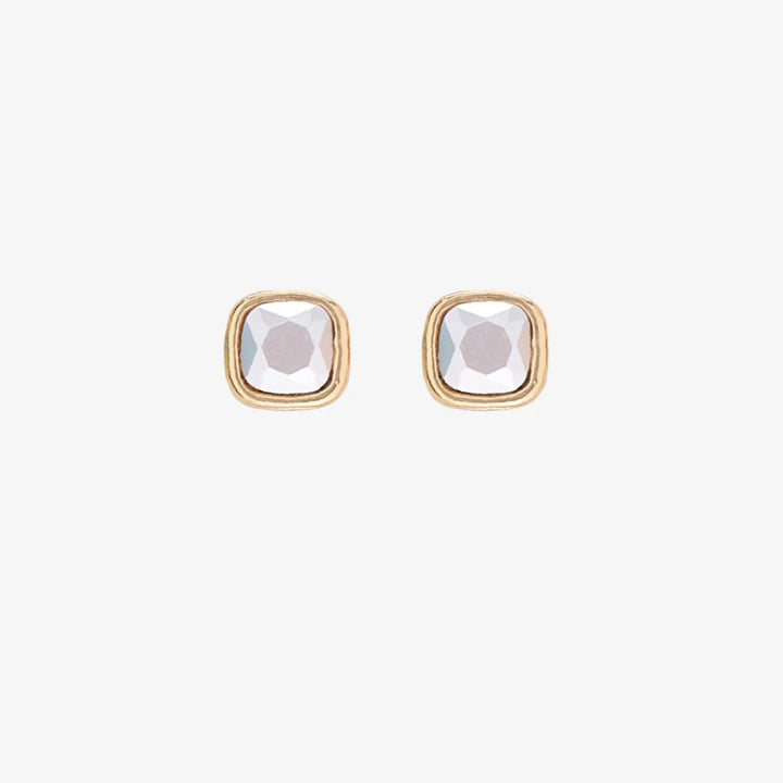 A set of three pairs of pearl earrings displayed on a blue card. The set includes a pair of stud earrings, a pair of bar earrings with small pearl beads, and a pair of hoop earrings with dangling pearl stones. The card has the month 