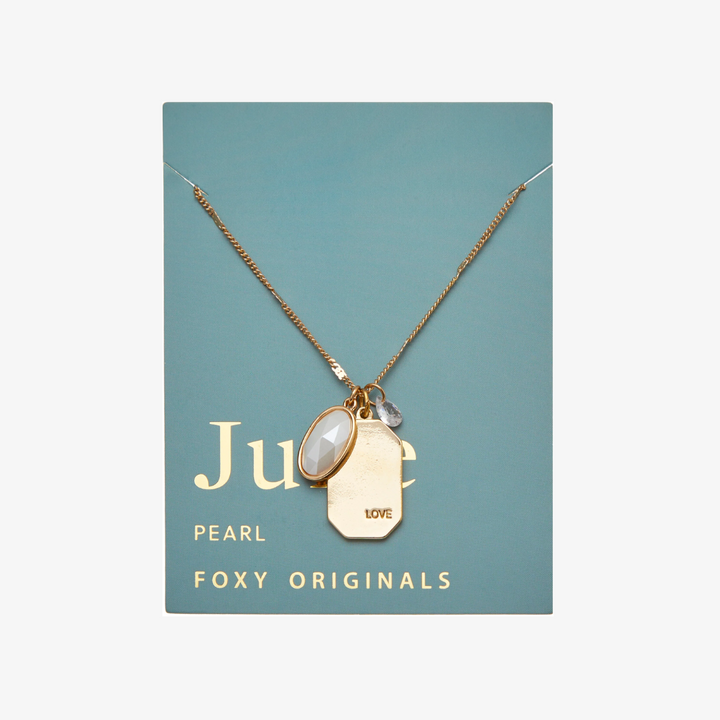 A gold necklace with a pearl stone pendant. The pendant also has the word 