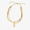 A gold layered bracelet with a small padlock charm. The bracelet has two chains of different widths, and the padlock charm hangs from the thinner chain.