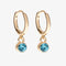 A set of three pairs of aquamarine earrings displayed on a light blue card. The set includes a pair of stud earrings, a pair of bar earrings with small aquamarine beads, and a pair of hoop earrings with dangling aquamarine stones. The card has the month 