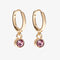 A set of three pairs of opal earrings displayed on a pink card. The set includes a pair of stud earrings, a pair of bar earrings with small opal beads, and a pair of hoop earrings with dangling opal stones. The card has the month 
