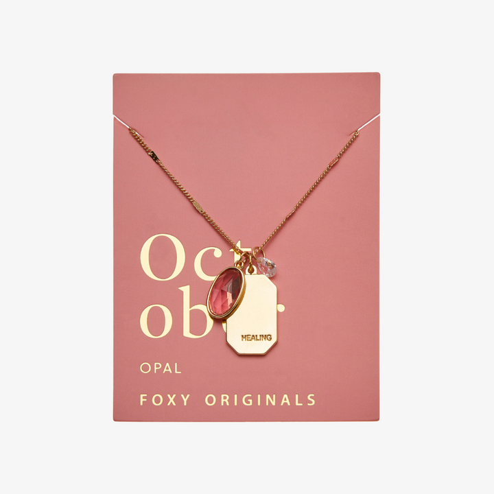 A gold necklace with an opal stone pendant. The pendant also has the word 