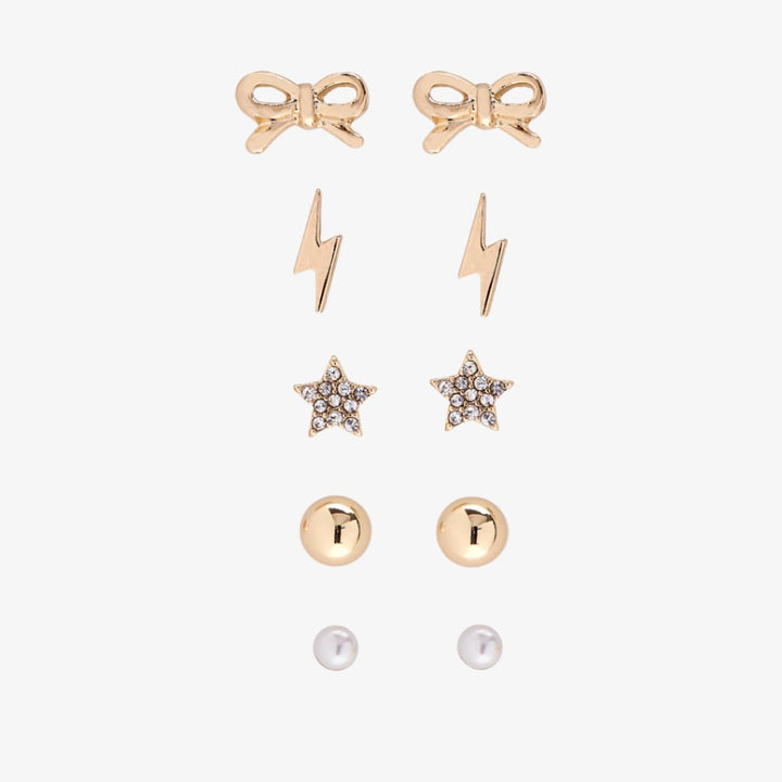 A set of gold stud earrings representing the days of the week. The earrings are arranged on a pink card with the words 