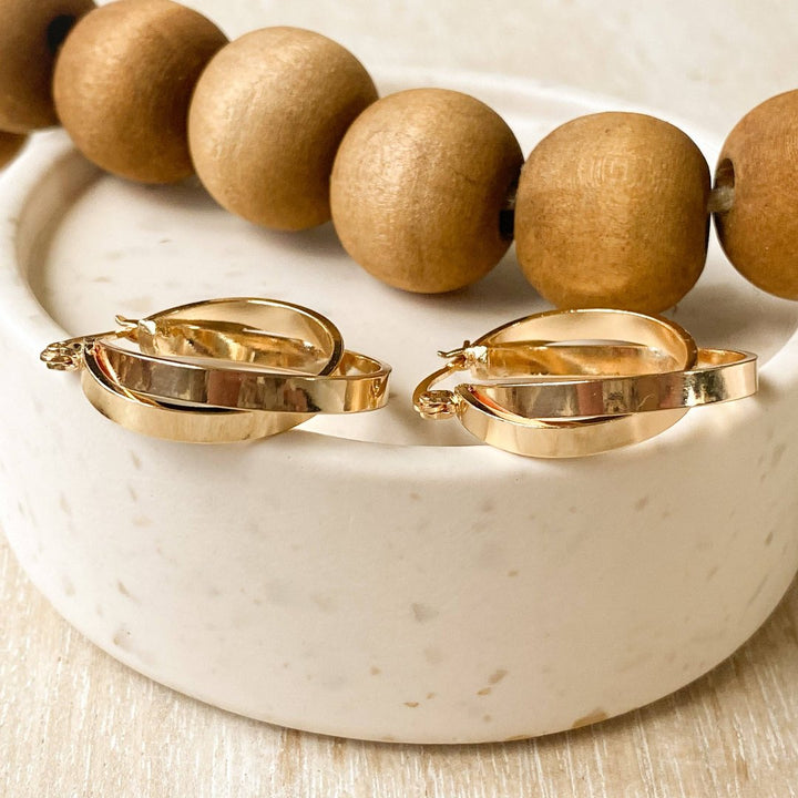 A pair of gold, double-layered hoop earrings.
