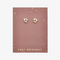 A pair of gold stud earrings with multiple rectangular crystals on a pink card with the brand name 