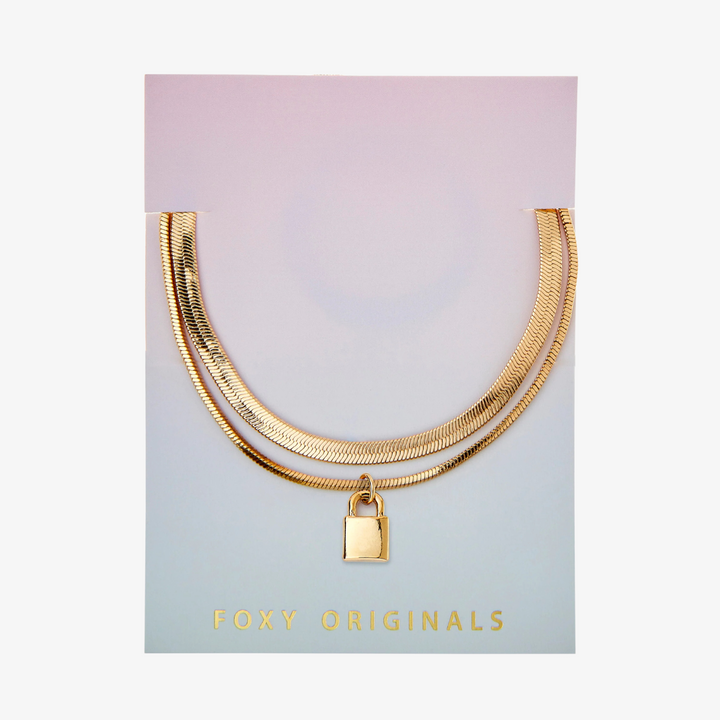 A gold layered bracelet with a small padlock charm. The bracelet has two chains of different widths, and the padlock charm hangs from the thinner chain.