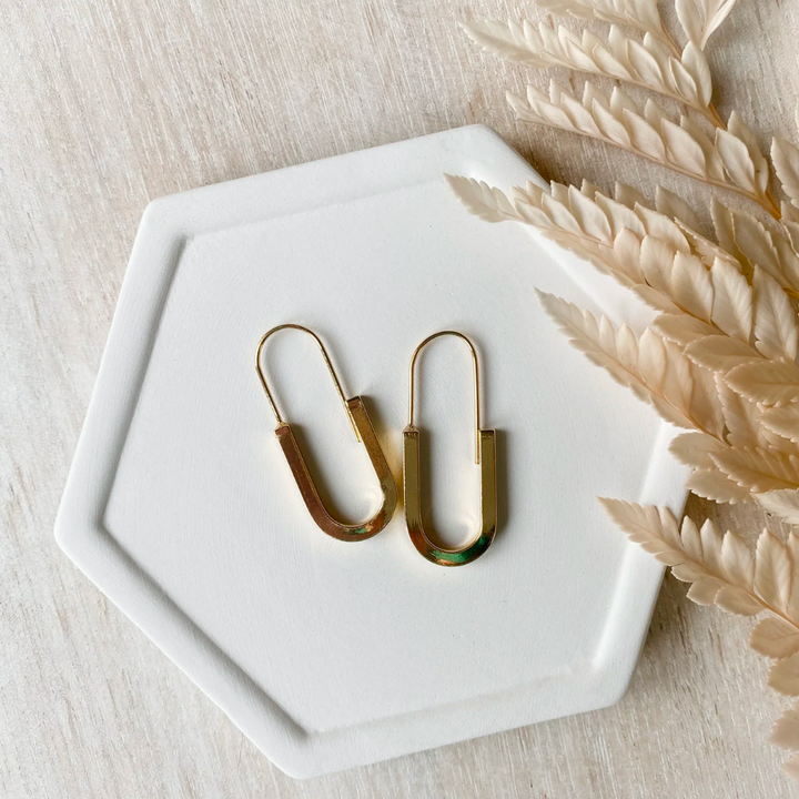 The Gold Minimalist Hoop is an ultra modern and sleek design and will be sure to keep you looking top notch. Nickel free and 14K gold plated.  Made in Canada. Close Up product image