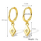 Gold plated diamond drop earrings featuring small gold hoops with dangling rhombus-shaped charms, each with a central sparkling crystal resembling a North Star. These elegant earrings are available in Ottawa, Ontario, Canada.