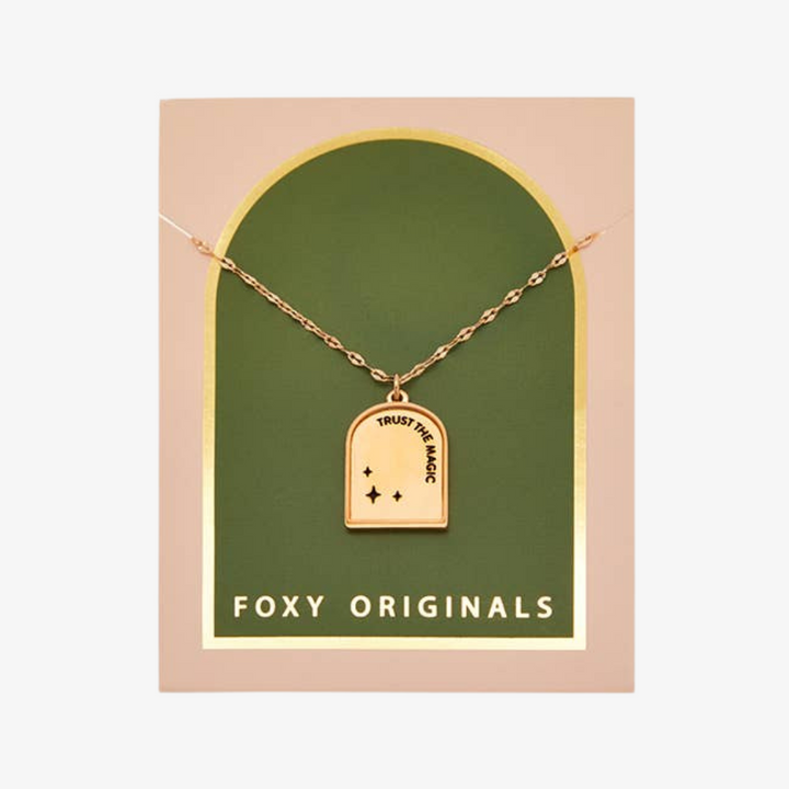 A gold necklace with a pendant shaped like an archway. The pendant has the words 