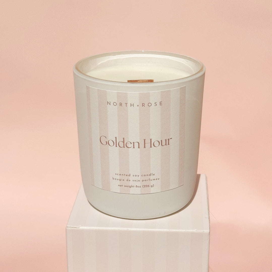 Candle with 'North & Rose Golden Hour' label on a pink background
