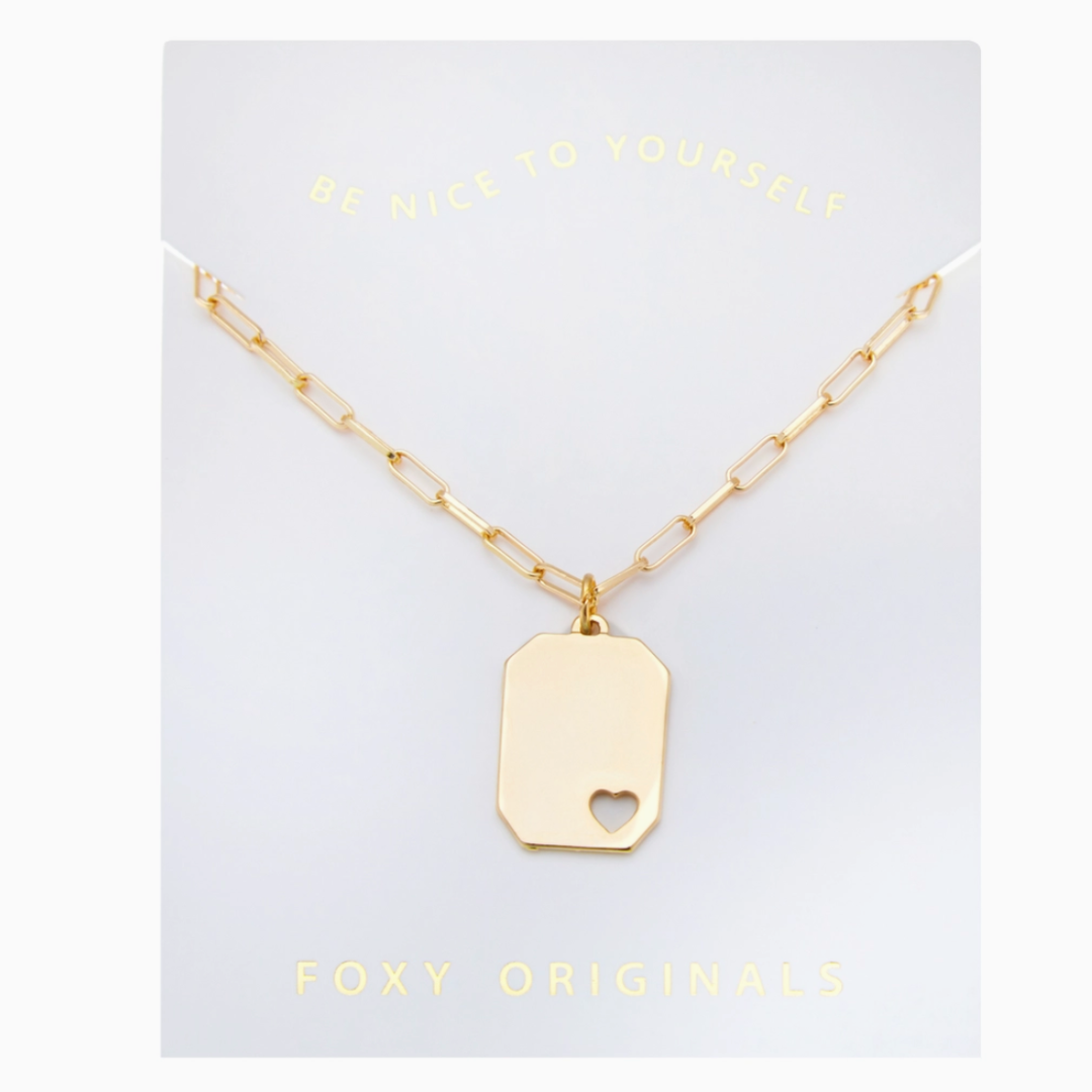 Gold necklace with a heart-shaped pendant on a 'Foxy Originals' card.