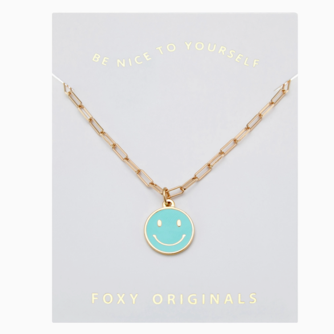 Necklace with a smiley face pendant on a 'Foxy Originals' card.