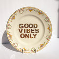 Decorative plate with 'Good Vibes Only' text on a white background