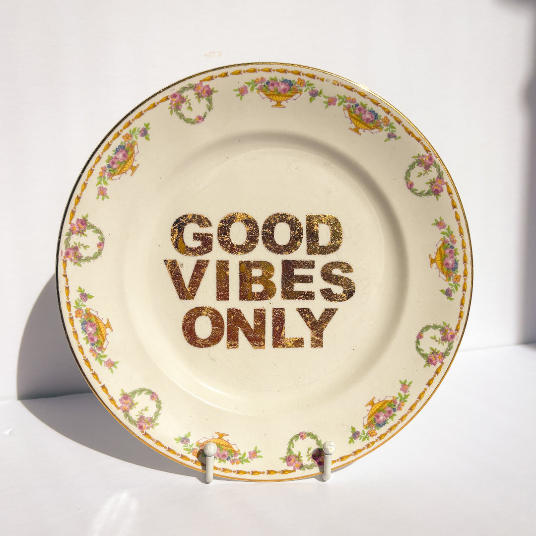 Decorative plate with 'Good Vibes Only' text on a white background