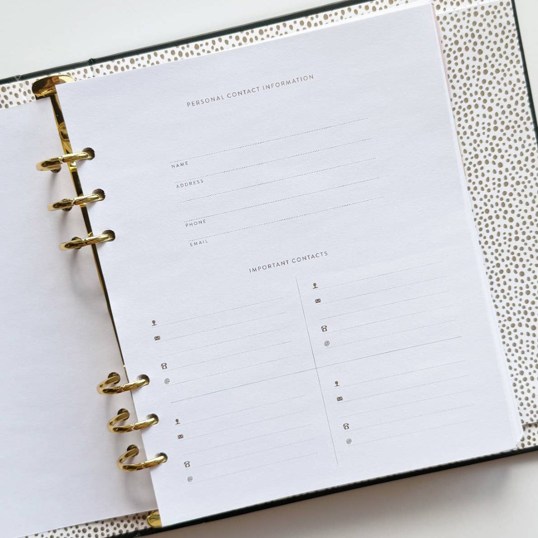 A black agenda with the phrase "It's Gonna Be A Great Year" written in colorful letters. The letters are outlined in gold and there are gold stars scattered around the text. The agenda has a purple elastic band.