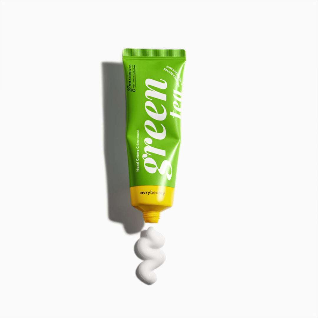 Green tube of toothpaste with white cream on a white background