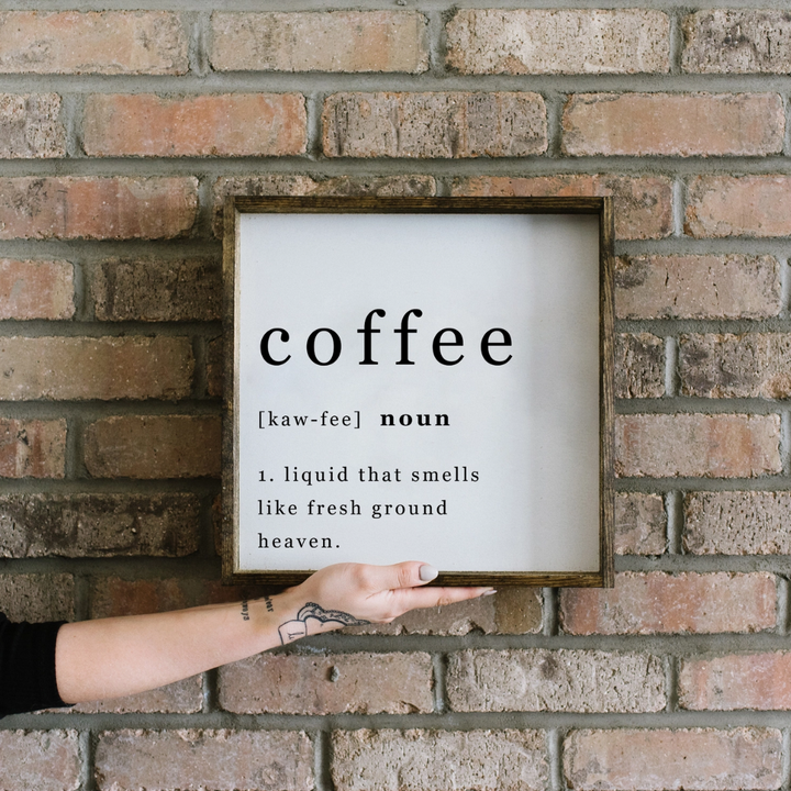 A framed square wood sign with the text 