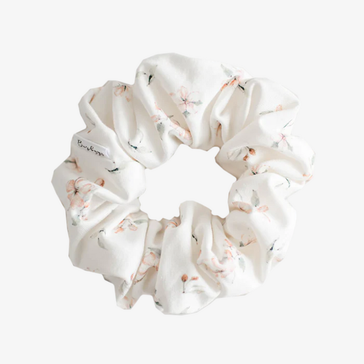 Cherry Blossom Petite Scunchie, a fluffy hair tie in white covered in small cherry blossoms.