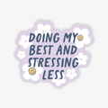 Doing My Best & Stressing Less Sticker, a purple stickers with white flowers and yellow happy faces that reads "doing my best and stressing less"