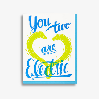 Electric Wedding Card, a white greeting card with the image of two electic eels in green that glow in the dark with the words 
