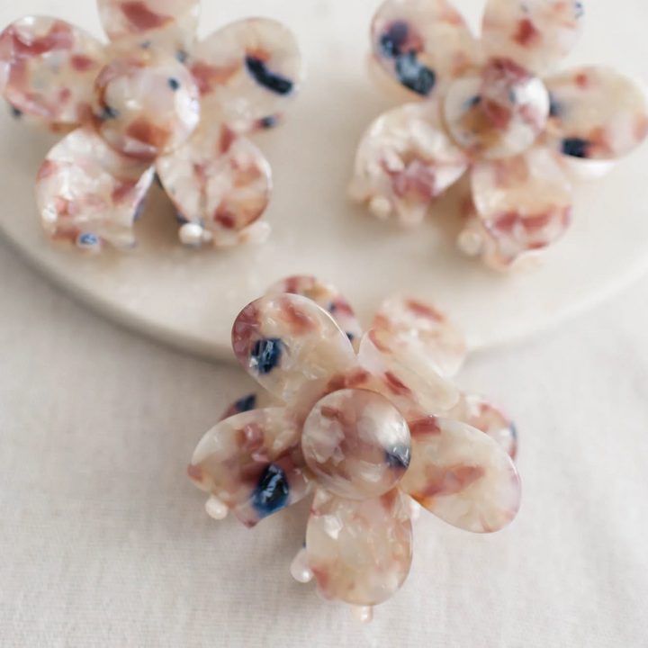 Three Spring Splash Floral Clips, floral hair clips with a vibrant mix of pink, white, and blue resin petals. The petals have a marbled effect.