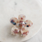 Spring Splash Floral Clip, floral hair clips with a vibrant mix of pink, white, and blue resin petals. The petals have a marbled effect.