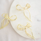 Gold Metallic Bow Clip, a claw clip in a gold metallic finish. Perfect for adding a feminine touch to any hairstyle.