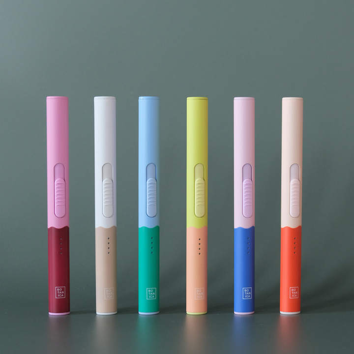 6 DuoTone Flameless Lighter in different colour combinations that include, pink and berry, white and beige, blue and green, yellow and peach, pink and blue, and peach and orange.