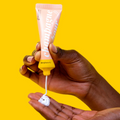 A hand squeezing the Champagne Hour Shea Butter Lotion into their other hand.
