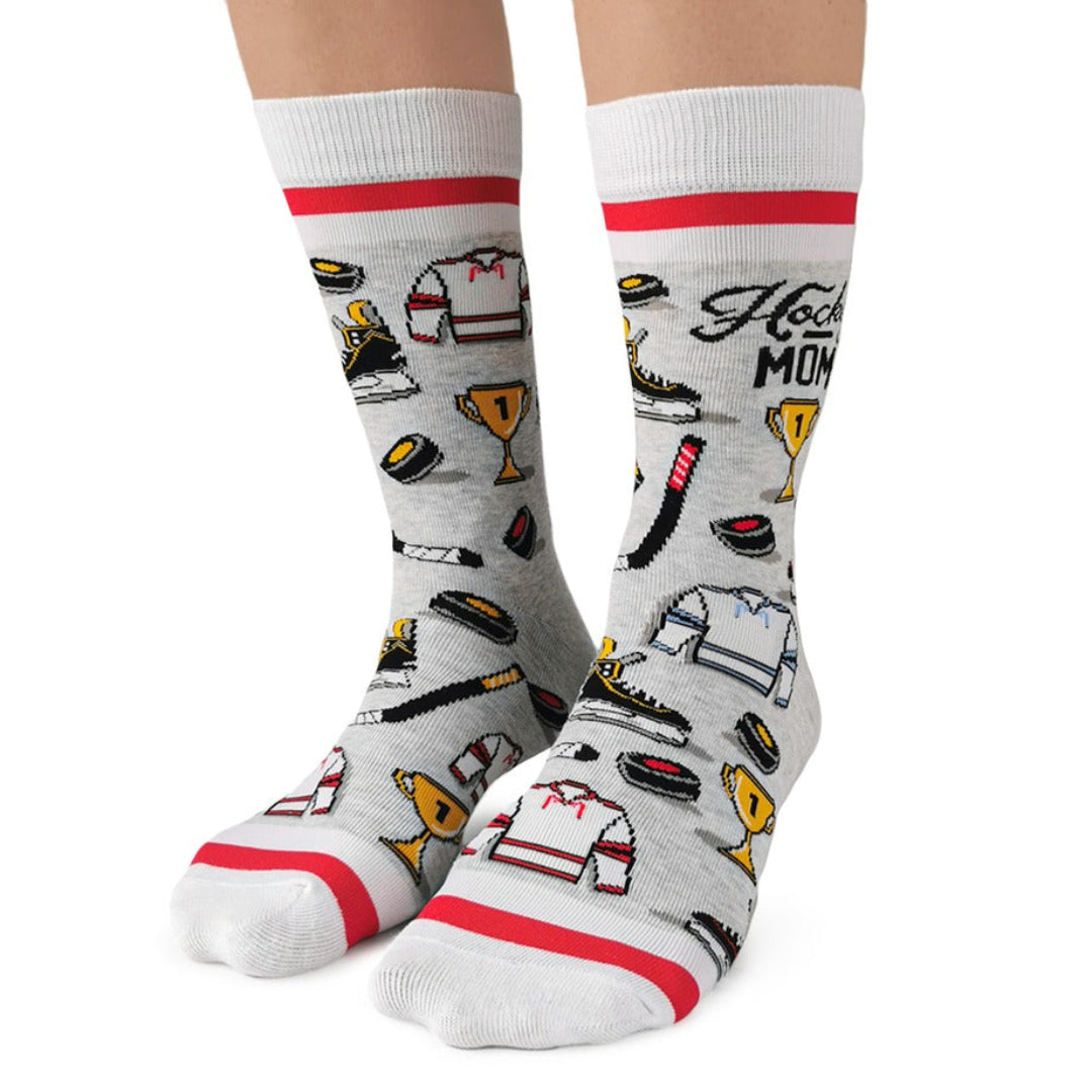 Gray socks with red accents and various icons worn by a person on a white background