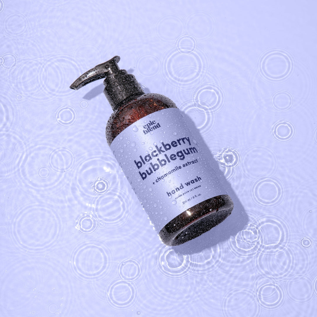 An amber plastic pump bottle of Epic Blend Blackberry Bubblegum Hand Wash with a light purple label. The label specifies "blackberry bubblegum + chamomile extract" and "hand wash".