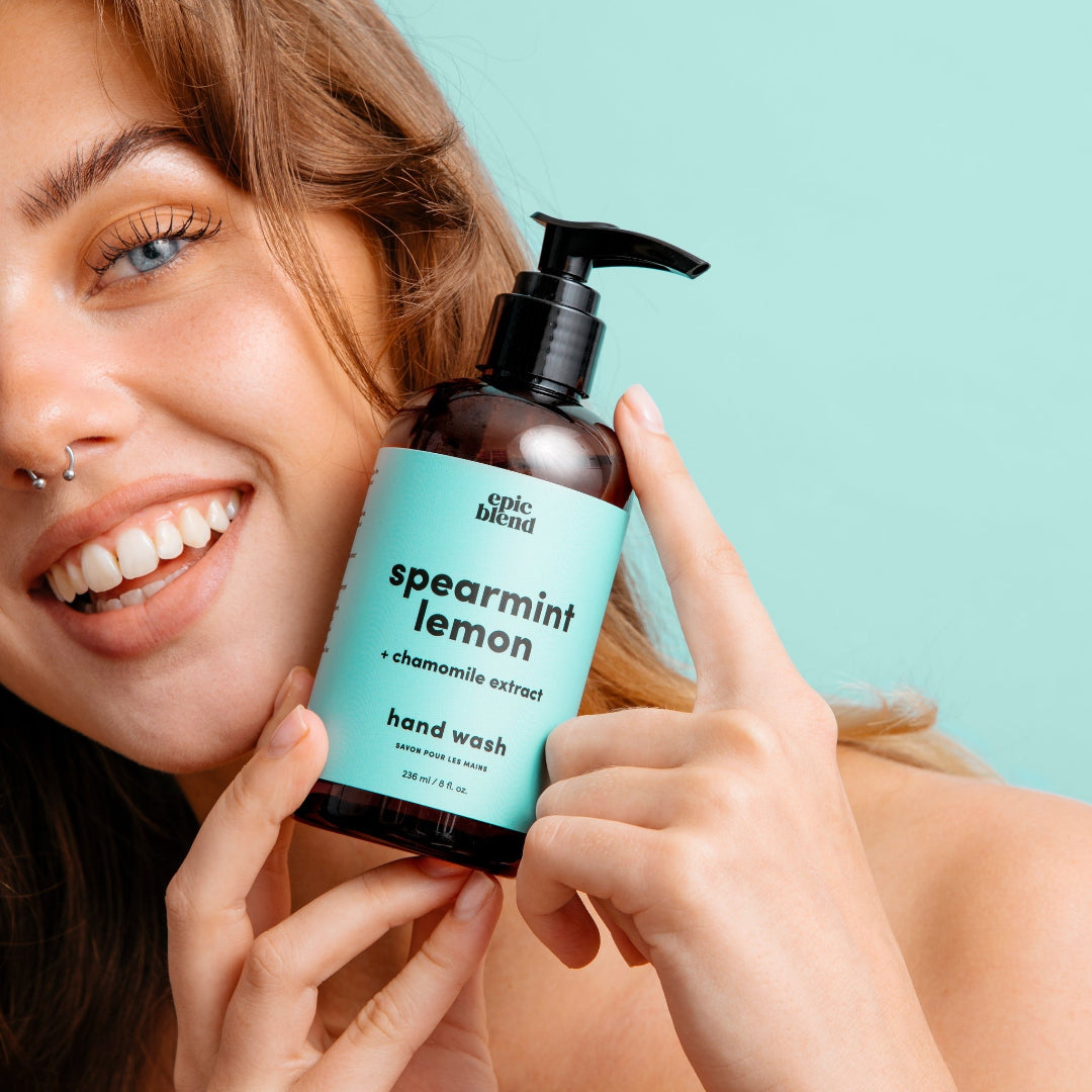 An amber plastic pump bottle of Epic Blend Spearmint Lemon Hand Wash with a light blue label. The label specifies "spearmint lemon + chamomile extract" and "hand wash".